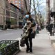 A woman carrying her pug in New York City in early April.